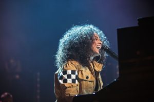 Alicia Keys singing on piano at Passport Summer Concert