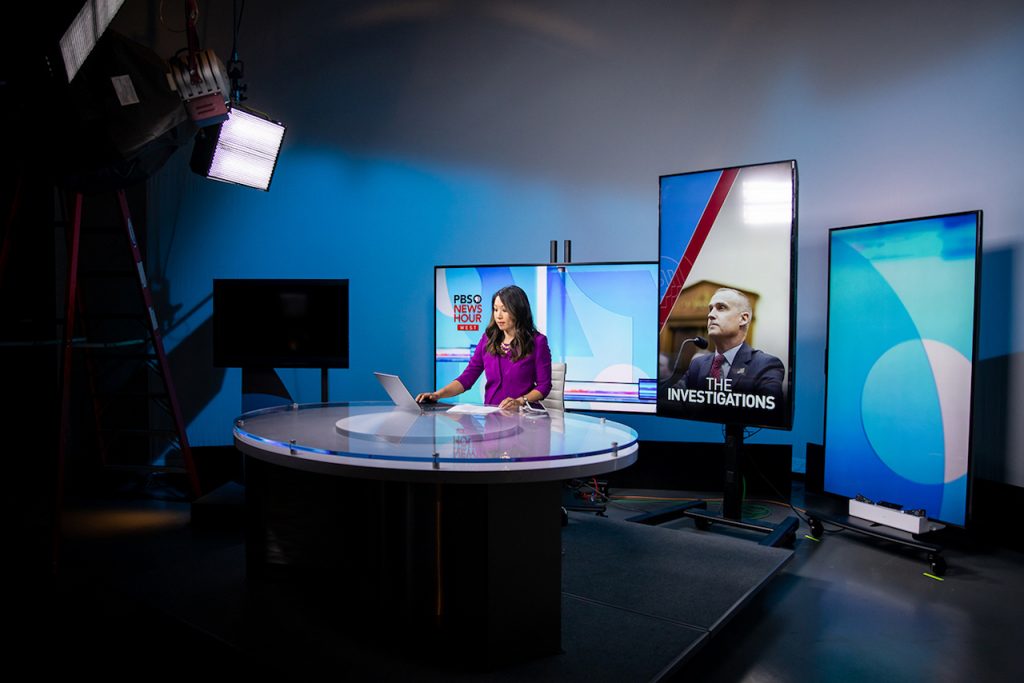 Stephanie Sy at the anchor desk of PBS NewsHour West