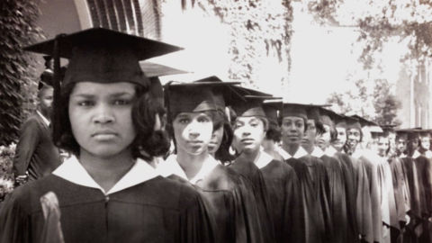 Black women wearing graduation regalia