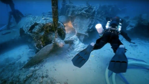 A diver explores the ruins of the B-24 crash site
