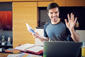 A teacher greets his online class.