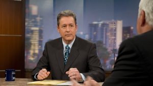 Ted Simons sitting with fists on desk
