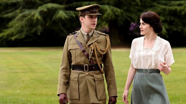 Matthew, in his British Army uniform, and Lady Mary stroll across the lawn in a scene from Downton Abbey, Season 2