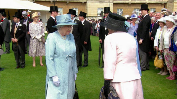 Queen Elizabeth standing in a garden