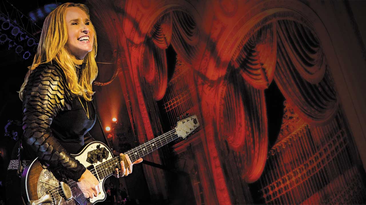 Melissa Etheridge performs on guitar
