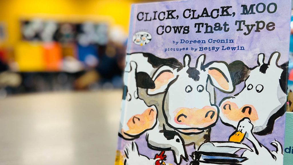 The book Click, Clack, Moo: Cows That Type is displayed in a classroom