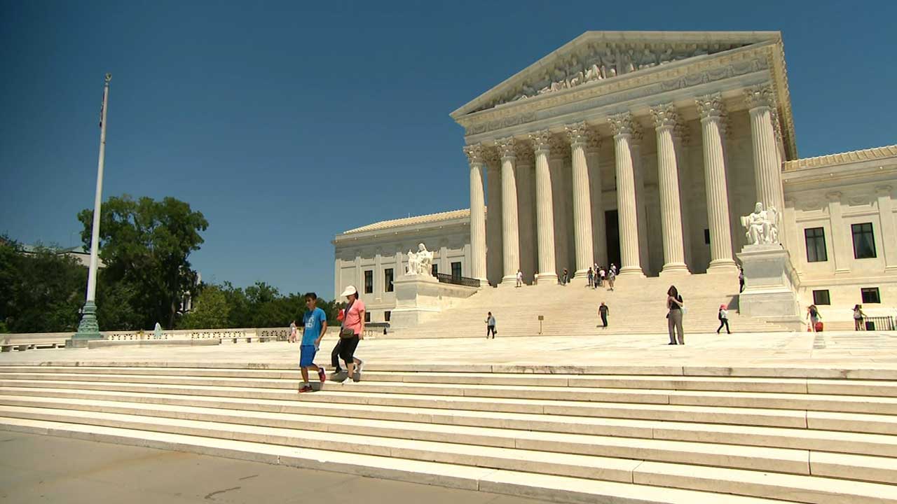 a mother and son walk down the steps of The Supreme Court