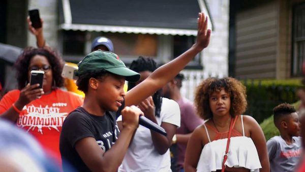 A woman makes a speech to the community
