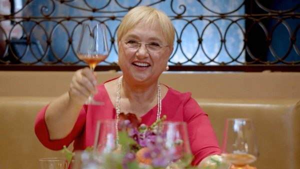 Lidia Bastianich raises a wine glass in celebration