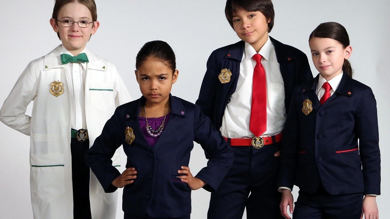 The Odd Squad cast stands together with a frowning Ms O in front.