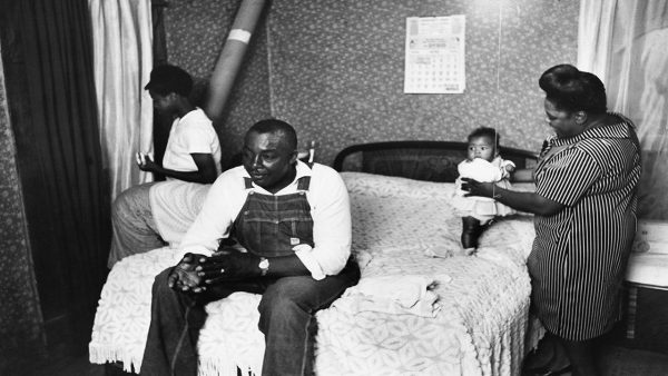 Foster mother to two children, Fannie Lou Hammer is photographed playing with seven-month-old Lenora Aretha.