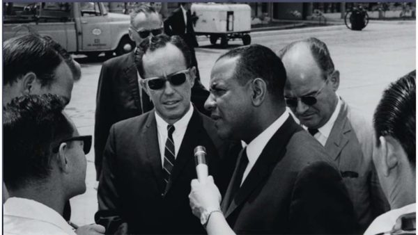 black man being interviewed by reporters