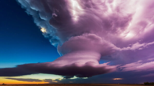 A tall purple storm cloud dominates the sky