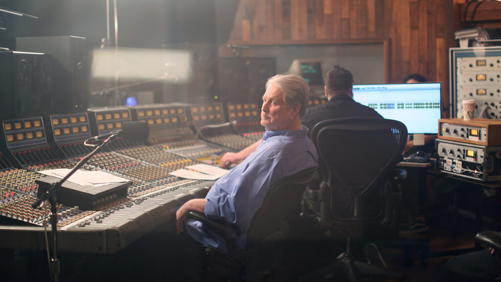 Brian Wilson of the Beach Boys sits in a recording studio