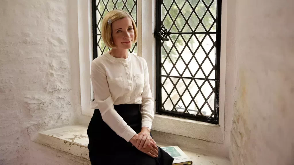 Lucy Worsley sits beside a window in the Tower of London