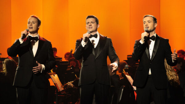The three members of Trinity perform in tuxedos