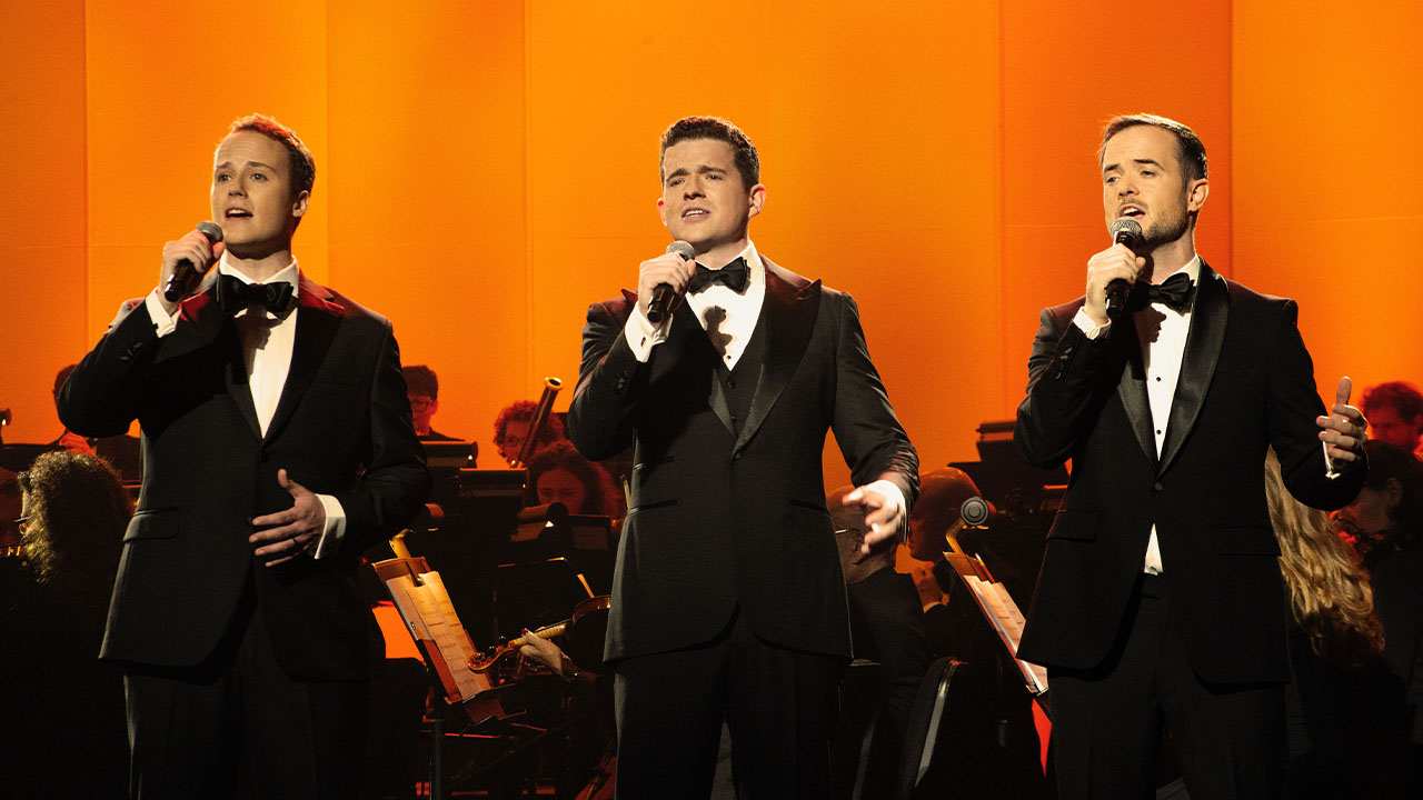 The three singers of Trinity perform in tuxedos
