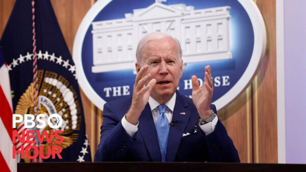 President Biden gestures with his hands as he gives an address at the White House