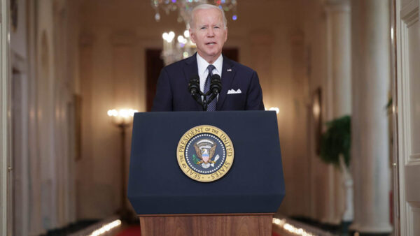 President Biden speaks from a podium at the White House