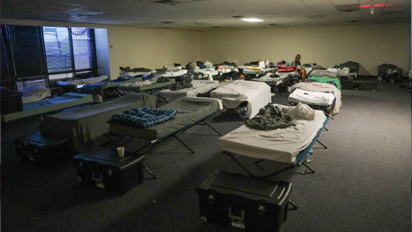 Beds lined up in a homeless shelter