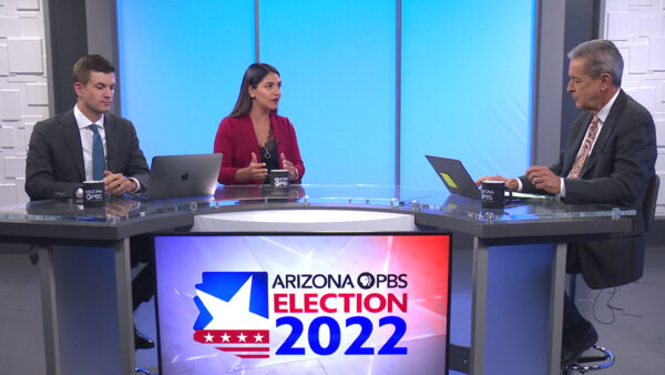 Two political analysts sit opposite Ted behind a desk on the set of Arizona Horizon