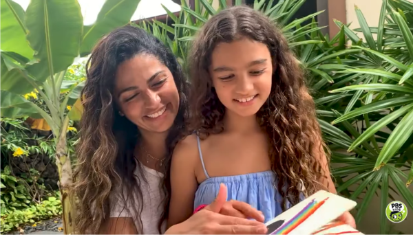 Camila Alves McCaughey reading with daughter a book.