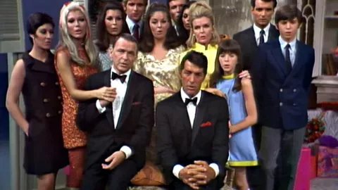 Frank Sinatra and Dean Martin, surrounded by family members