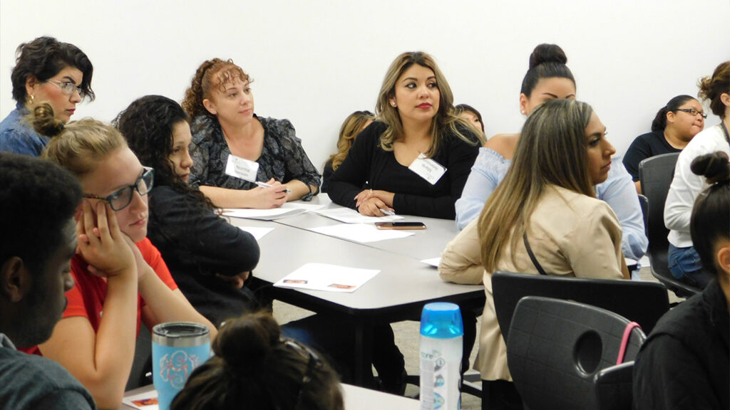 A group of Professional Development students sits in a session