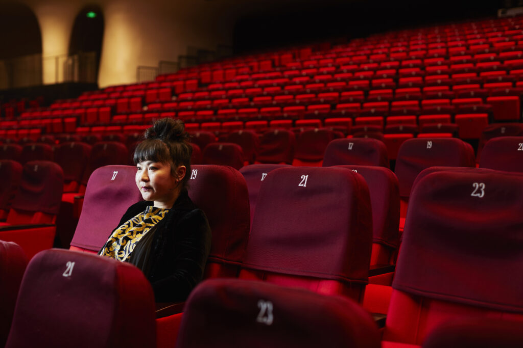 Du Yun sitting in an empty theater