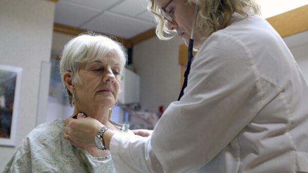 An Alzheimer's patient getting a check up from a doctor