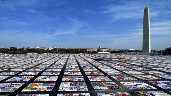 A view of the Washington Monument with collages on the lawn surrounding it