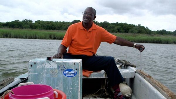 A man on a boat in a salt marsh in South Carolina