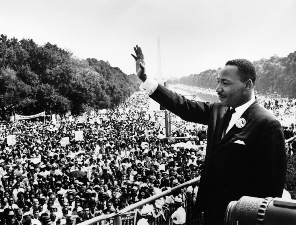 Martin Luther King Jr. waving to the crowd