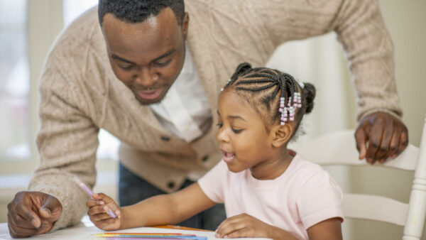 A father teaches his daughter about Black art