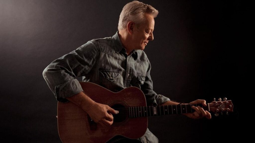 Tommy Emmanuel plays the guitar