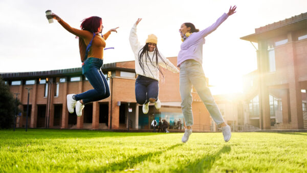 High school students excitedly jump in the air
