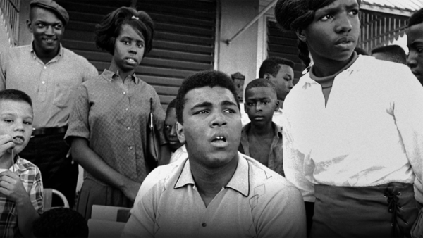 Muhammad Ali visits with children in the community