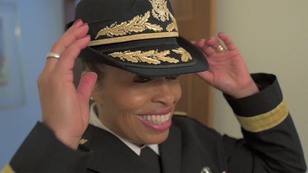 Major General Marcia Anderson putting on her hat