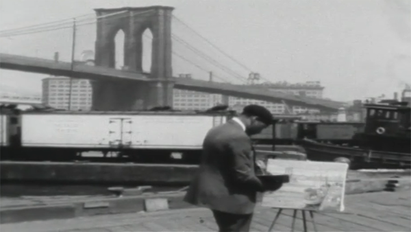 black and white of man painting a bridge