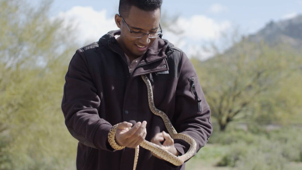 Isaac "Ike" Easley holds a snake