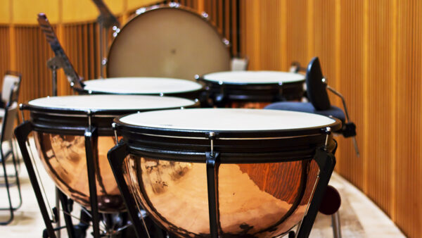 timpani drums on a concert stage. Bass drum in the background