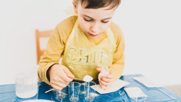 A young boy participates in a STEM activity
