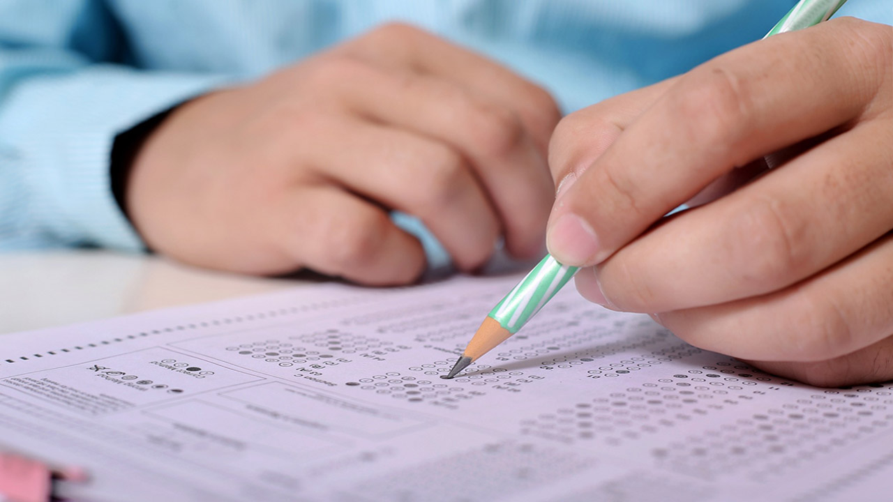 A student uses a pencil to take a standardized test
