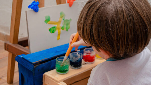 A young boy works on a painting