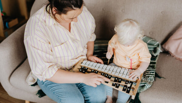 Mom and baby play with a xylophone
