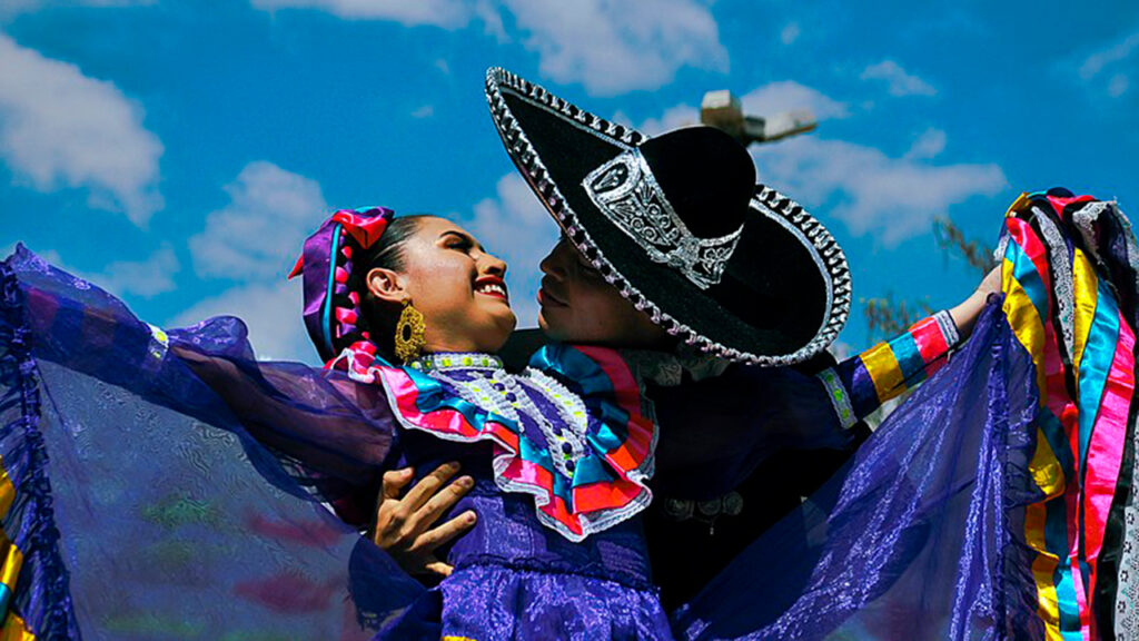 couple dancing in traditional Mexican attire