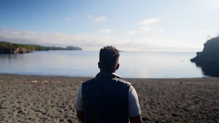 man looking out at outdoor landscape