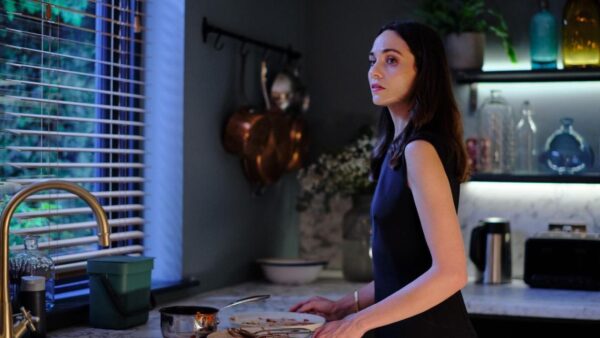 The main character stands in her kitchen in the PBS show 