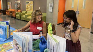Author Phoebe Fox signs books at the Arizona PBS Writing Contest celebration