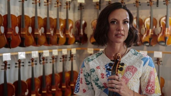 A woman holds a fiddle on Southern Storytellers Part 2
